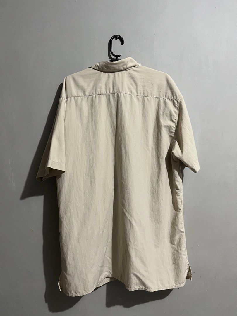 Stones Collection Short Sleeve Button Up Shirt (Category: Tshirts & Polo Shirts ) located in Cavite. Submitted by nathanluis (Listing ID 1452791882, Image 2). Description: - Lightweight short sleeve shirt from Stones Collection. - Classic button-up style. - Two chest pockets. - Neutral beige color, versatile for pairing. - Ideal for casual wear or layering. Issue: missing button on lower middle, replaceable.