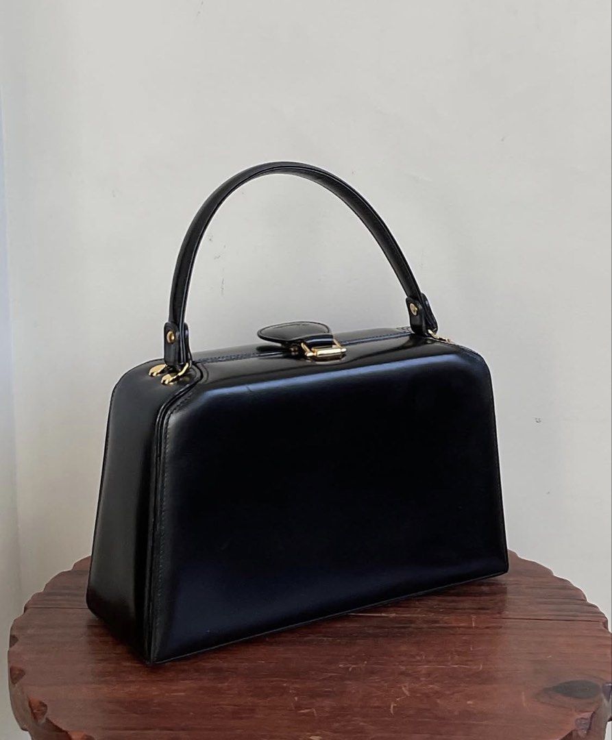 Structured Vintage Box Calf Leather Handbag (Category: Luxury Bags & Wallets) located in Quezon City. Submitted by vwfndrskprs (Listing ID 1452869104, Image 2). Description: - Vintage black top handle handbag from Japan - Structured - shiny box calf leather - Secure gold-tone magnetic clasp closure - has feet at the bottom - super clean interior with 2 main compartments and 2 interior pockets - 9/10 very good condition, with minimal shallow scrat