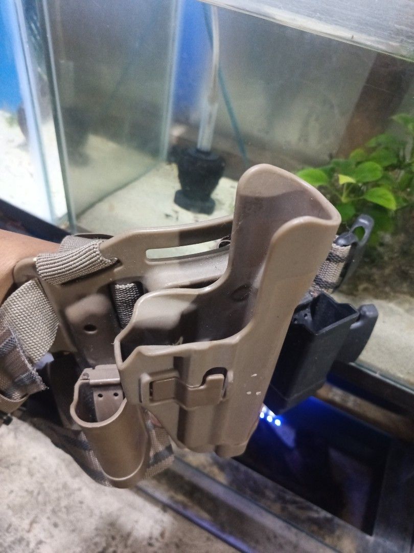 Tactical Vest, Holster, Knee Pads Set (Category: Other Sports Equipment and Supplies) located in Caloocan City. Submitted by aquasaurus (Listing ID 1452806960, Image 1). Description: Tactical drop leg holster with a magazine pouch. Also comes with a pair of knee pads. Tan and black color scheme. Great for airsoft or tactical training..