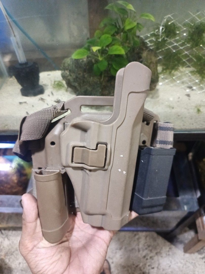 Tactical Vest, Holster, Knee Pads Set (Category: Other Sports Equipment and Supplies) located in Caloocan City. Submitted by aquasaurus (Listing ID 1452806960, Image 3). Description: Tactical drop leg holster with a magazine pouch. Also comes with a pair of knee pads. Tan and black color scheme. Great for airsoft or tactical training..