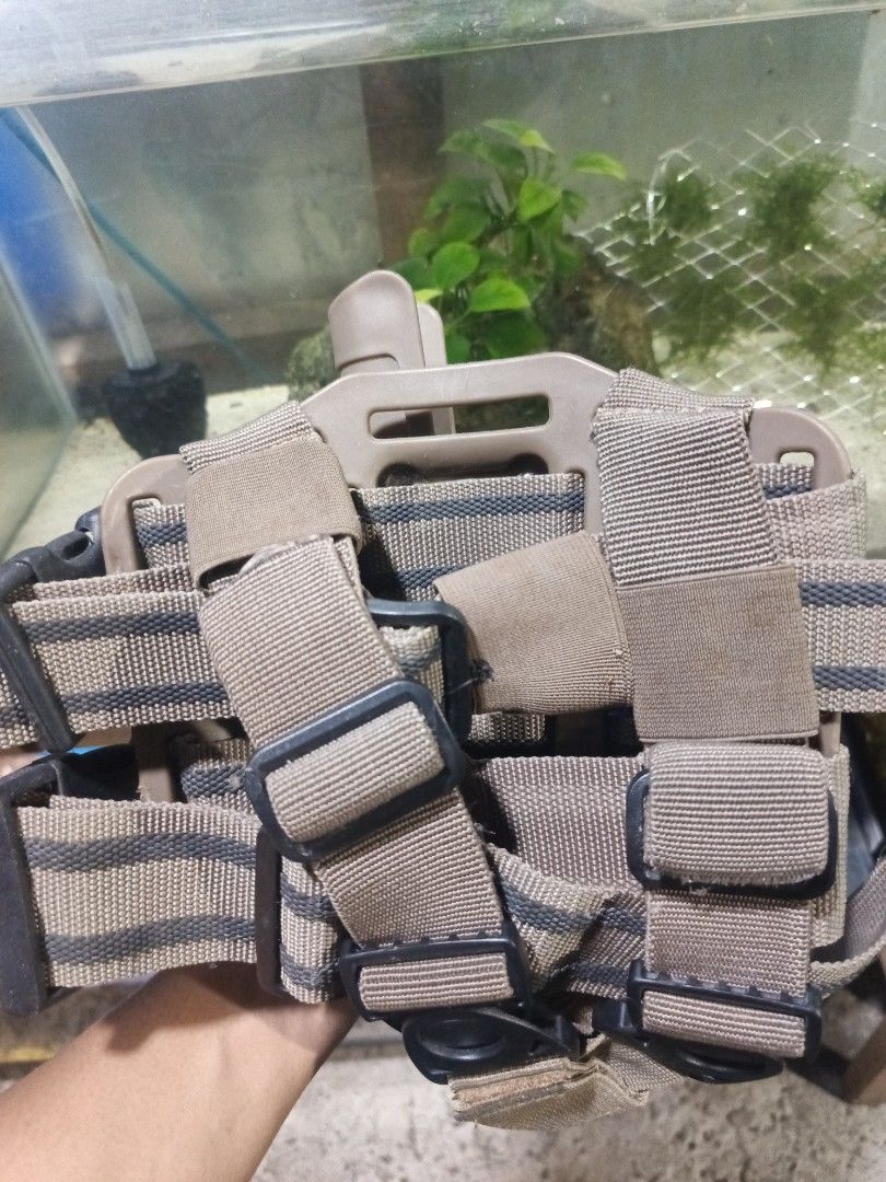 Tactical Vest, Holster, Knee Pads Set (Category: Other Sports Equipment and Supplies) located in Caloocan City. Submitted by aquasaurus (Listing ID 1452806960, Image 2). Description: Tactical drop leg holster with a magazine pouch. Also comes with a pair of knee pads. Tan and black color scheme. Great for airsoft or tactical training..