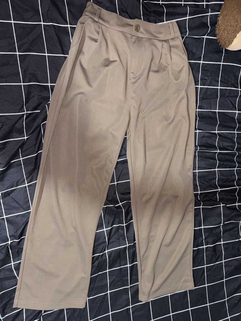 Taupe Pleated Trousers (Category: Other Bottoms) located in Pasay City. Submitted by a.daneee (Listing ID 1452836660, Image 1). Description: - Classic taupe trousers with a pleated front. - Smooth fabric that drapes beautifully. - Secure button and zip closure at the waist. - Relaxed fit with a straight leg. - Versatile for both casual and smart-casual outfits..