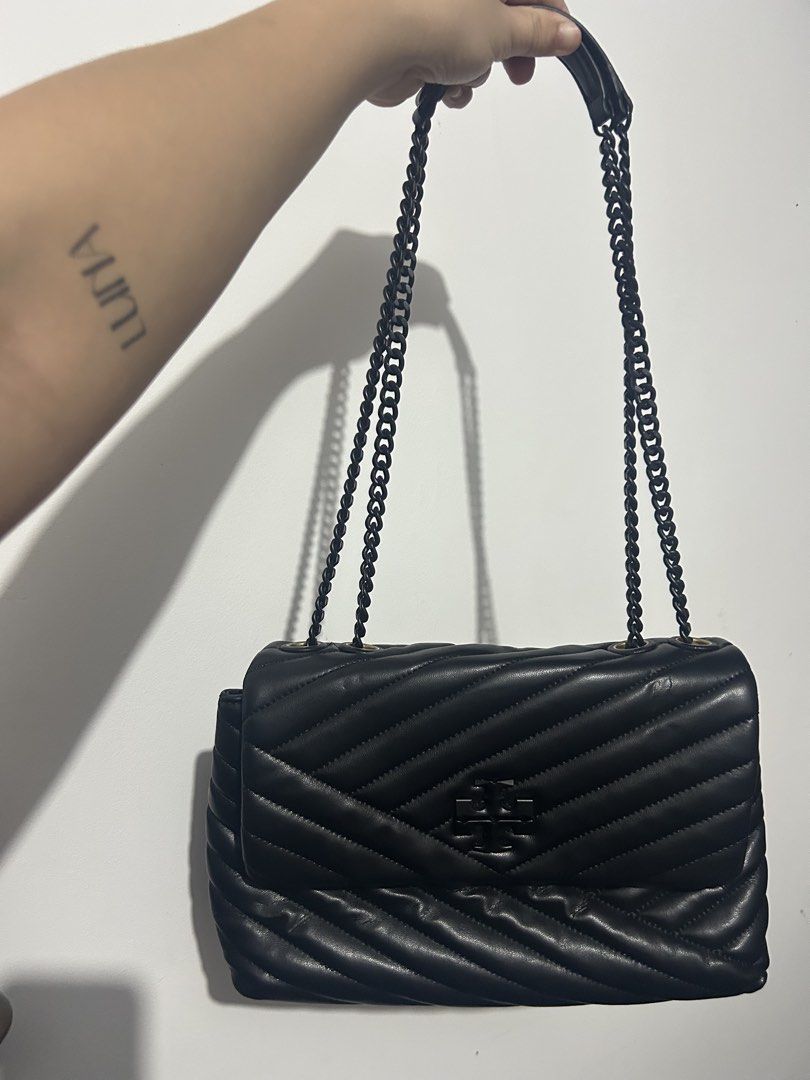Tory Burch Black Chevron Leather Chain Shoulder Bag (Category: Luxury Bags & Wallets) located in Makati City. Submitted by michellecollado07 (Listing ID 1452801778, Image 1). Description: NOT AUTHENTIC Genuine black leather shoulder bag - Elegant chevron quilting pattern - Iconic Tory Burch logo on the front - Stylish black chain strap - Secure gold hardware flap closure - Versatile for day or evening wear - Spacious enough for daily essentials.