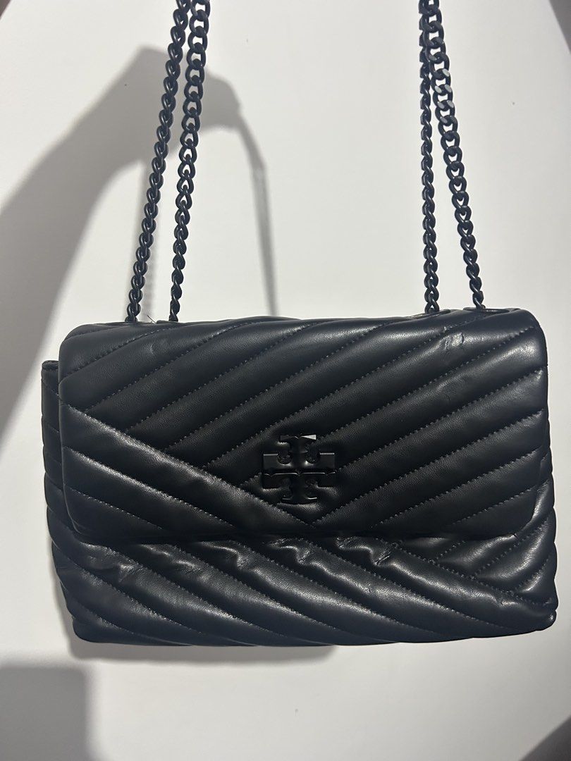 Tory Burch Black Chevron Leather Chain Shoulder Bag (Category: Luxury Bags & Wallets) located in Makati City. Submitted by michellecollado07 (Listing ID 1452801778, Image 3). Description: NOT AUTHENTIC Genuine black leather shoulder bag - Elegant chevron quilting pattern - Iconic Tory Burch logo on the front - Stylish black chain strap - Secure gold hardware flap closure - Versatile for day or evening wear - Spacious enough for daily essentials.