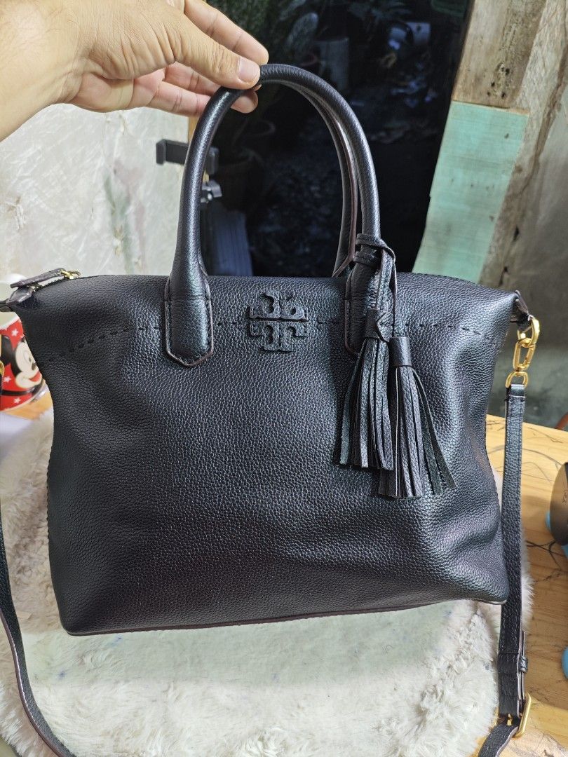 Tory Burch McGraw Slouchy Satchel (Category: Luxury Bags & Wallets) located in Davao. Submitted by skankinpotato101 (Listing ID 1452748816, Image 1). Description: - Black pebbled leather tote bag - Top handles - Detachable crossbody strap - Gold-tone hardware - Tassel detail - Zipper closure - Spacious interior - Ideal for everyday use.