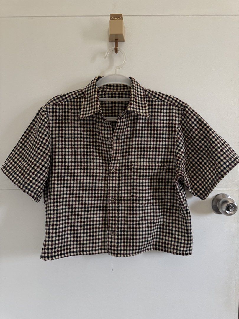 Vintage Plaid Cropped Short Sleeve Button-Down Top (Category: Shirts) located in Marikina City. Submitted by hellolei_c (Listing ID 1452807973, Image 1). Description: Pattern: Gingham / Mini Plaid / Checkered Style: Boxy / Cropped / Casual / Vintage / Streetwear Sleeve Length: Short sleeves Size: Medium Features: Front chest pocket, functional buttons, collar Color: Cream, Burgundy/Brown, Black Note: Please check photos for exact details :).
