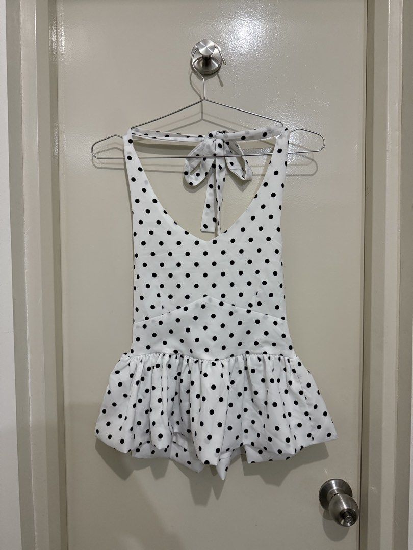 White Black Polka Dot Halterneck Peplum Top (Category: Sleeveless) located in Pasig City. Submitted by rchsh (Listing ID 1452825685, Image 1). Description: - Cute white halterneck top - Black polka dot print - Tie-up halterneck - Smocked back for a comfy fit - Playful peplum hem - Ideal for casual outings or beach days Only used once.