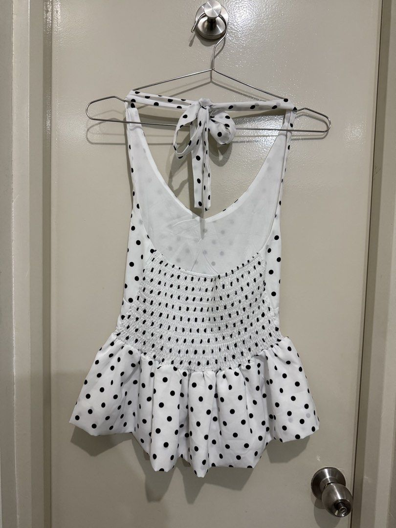 White Black Polka Dot Halterneck Peplum Top (Category: Sleeveless) located in Pasig City. Submitted by rchsh (Listing ID 1452825685, Image 2). Description: - Cute white halterneck top - Black polka dot print - Tie-up halterneck - Smocked back for a comfy fit - Playful peplum hem - Ideal for casual outings or beach days Only used once.