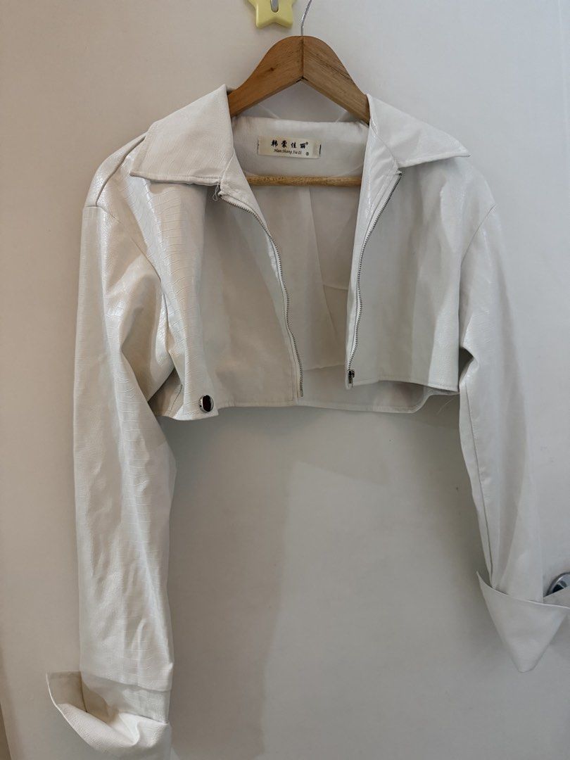 White Cropped Faux Leather Jacket (Category: Coats, Jackets and Outerwear) located in Cebu City. Submitted by moonglare.cebu (Listing ID 1452877190, Image 2). Description: - Super cute white cropped jacket - Faux leather with subtle texture - Zip-up front with collar - Long sleeves with wide cuffs - Ideal for layering over tops or dresses - Unique piece.