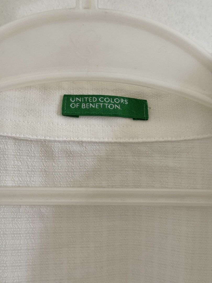 White Cropped Short Sleeve Button-Down Top (Category: Blouses) located in Marikina City. Submitted by hellolei_c (Listing ID 1452810690, Image 2). Description: Brand: United Colors of Benetton Color: White Style: Cropped / Boxy / Casual Polo / Lightweight / Minimalist Size: Medium Fabric/Texture: Lightweight, breathable, semi-sheer weave Sleeve Length: Short sleeves Features: Pointed collar, full front button closure.