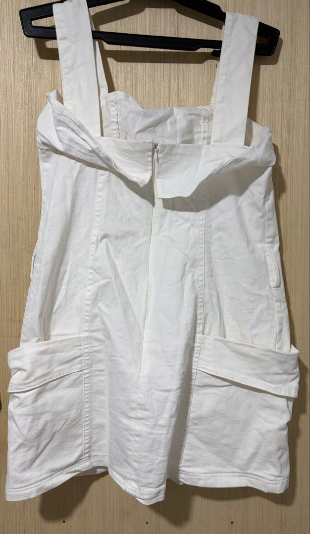 White Denim Pinafore Dress with Pockets (Category: Dresses) located in Pasay City. Submitted by a.daneee (Listing ID 1452835623, Image 2). Description: - Classic white denim pinafore dress - Two large front pockets - Adjustable straps for a perfect fit - Convenient back zipper closure - Simple and versatile style, great for layering.