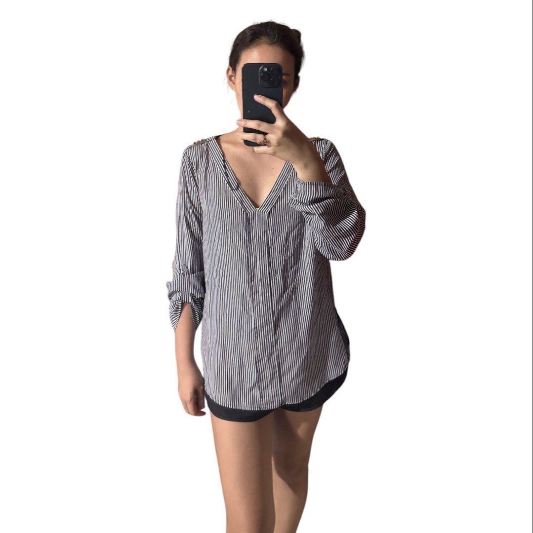 Zara Basic Striped V-Neck Blouse with Gold Shoulder Detail (Category: Blouses) located in Marikina City. Submitted by 1stuffshop (Listing ID 1452725260, Image 3). Description: - Zara Basic navy and white striped blouse - V-neckline with subtle gold shoulder detail - Three-quarter sleeves with a rolled-up effect - Relaxed fit with side slits - Versatile for casual outings or office wear Need to declutter clothes that are not my size anymore..