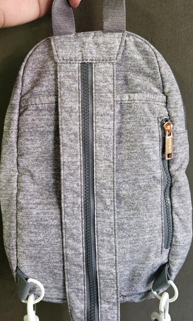 Adidas Essentials 2-Way Convertible Mini Backpack / Sling Bag (Heather Gray) (Category: Backpacks) located in Cavite. Submitted by aiomie.0021 (Listing ID 1452885500, Image 2). Description: *Brand: Adidas *Condition: Like New, no flaws, no stains, no scuffs, and zero interior lining issues. Zippers glide perfectly. Used once only. *Color: Heather Jersey Gray with Rose Gold hardware *Style: Convertible 2-Way (Can be styled as a standard mini backp