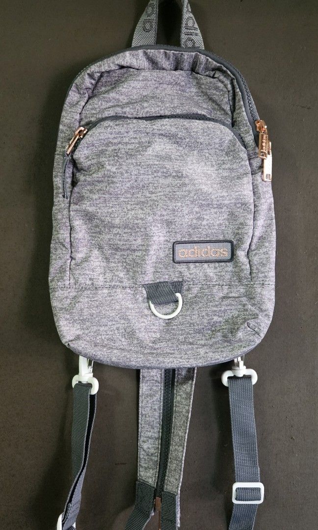 Adidas Essentials 2-Way Convertible Mini Backpack / Sling Bag (Heather Gray) (Category: Backpacks) located in Cavite. Submitted by aiomie.0021 (Listing ID 1452885500, Image 1). Description: *Brand: Adidas *Condition: Like New, no flaws, no stains, no scuffs, and zero interior lining issues. Zippers glide perfectly. Used once only. *Color: Heather Jersey Gray with Rose Gold hardware *Style: Convertible 2-Way (Can be styled as a standard mini backp