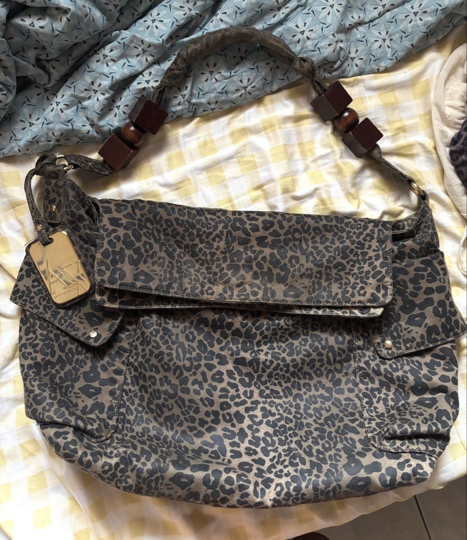 Armani Exchange large leopard print shoulder bag (Category: Shoulder Bags) located in Cabuyao City. Submitted by nevernotdecluttering (Listing ID 1452921320, Image 3). Description: unsure of the year, but this one's v old na HEAVILY USED (please view all photos) But aaahhh it's so pretty and unique 2 LARGE side pockets magnetic closure 1 zipper compartment inside has a gold finish metal plate/tag wood accents can easily fit a 13" laptop with slee