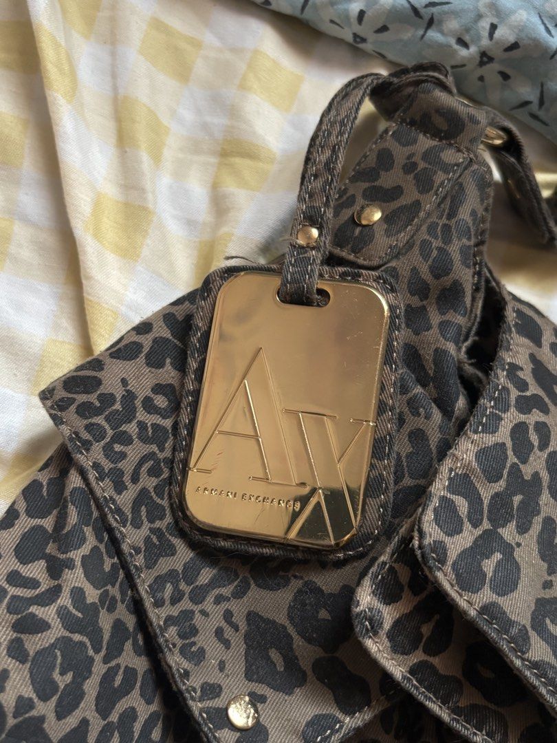 Armani Exchange large leopard print shoulder bag (Category: Shoulder Bags) located in Cabuyao City. Submitted by nevernotdecluttering (Listing ID 1452921320, Image 2). Description: unsure of the year, but this one's v old na HEAVILY USED (please view all photos) But aaahhh it's so pretty and unique 2 LARGE side pockets magnetic closure 1 zipper compartment inside has a gold finish metal plate/tag wood accents can easily fit a 13" laptop with slee