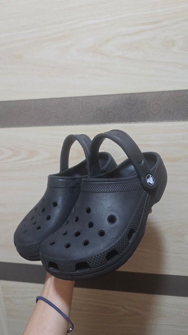 Black Crocs Classic Clog Sandals (Category: Babies & Kids Fashion) located in Quezon City. Submitted by mbpreloved65 (Listing ID 1453000266, Image 2). Description: - Classic black Crocs clogs - Easy slip-on and off design - Adjustable strap (wear up or down) - Ideal for everyday wear, beach trips, and lounging - Comfortable and durable construction - A versatile wardrobe staple.