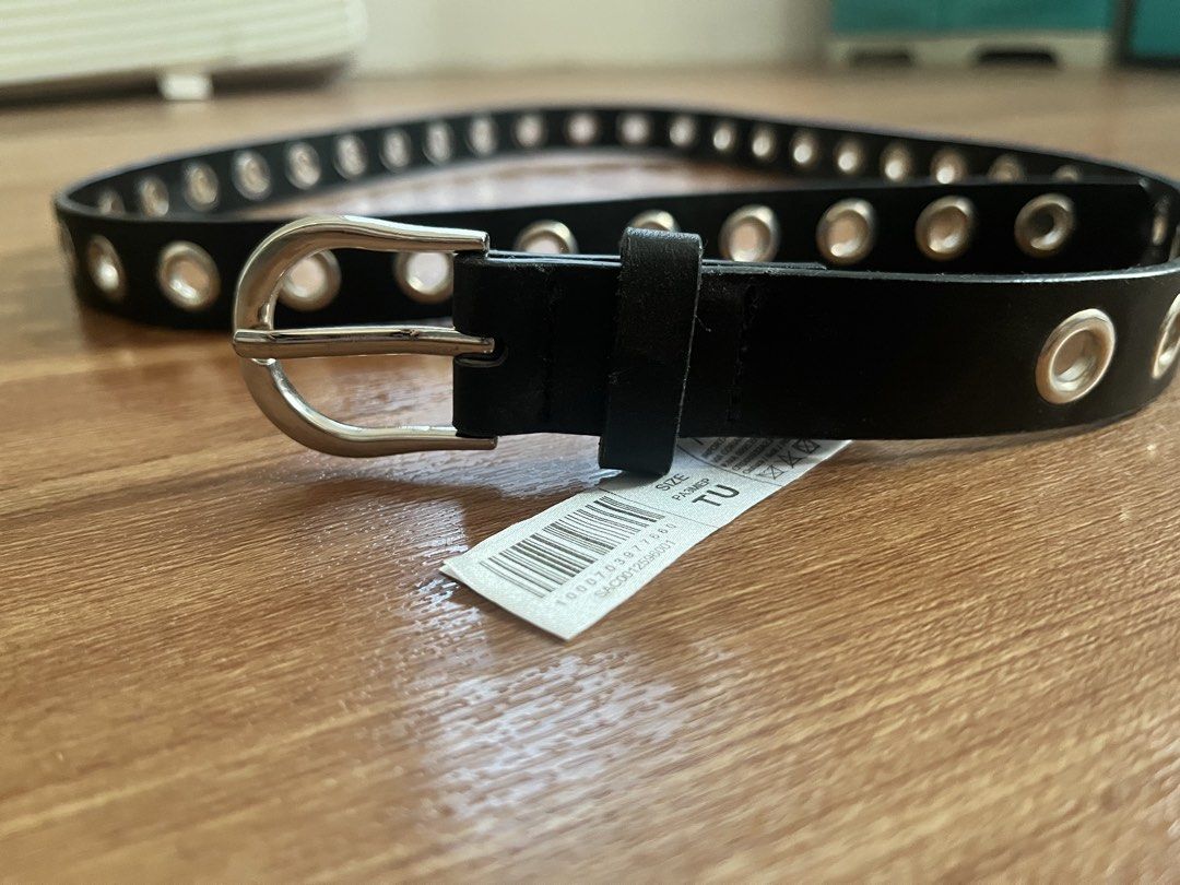 Black Eyelet Belt with Silver Buckle (Category: Belts) located in San Pablo. Submitted by celgvr (Listing ID 1453048114, Image 1). Description: - Black belt with silver eyelets all around - Features a silver buckle - Tag indicates size TU - A versatile accessory to elevate any outfit.