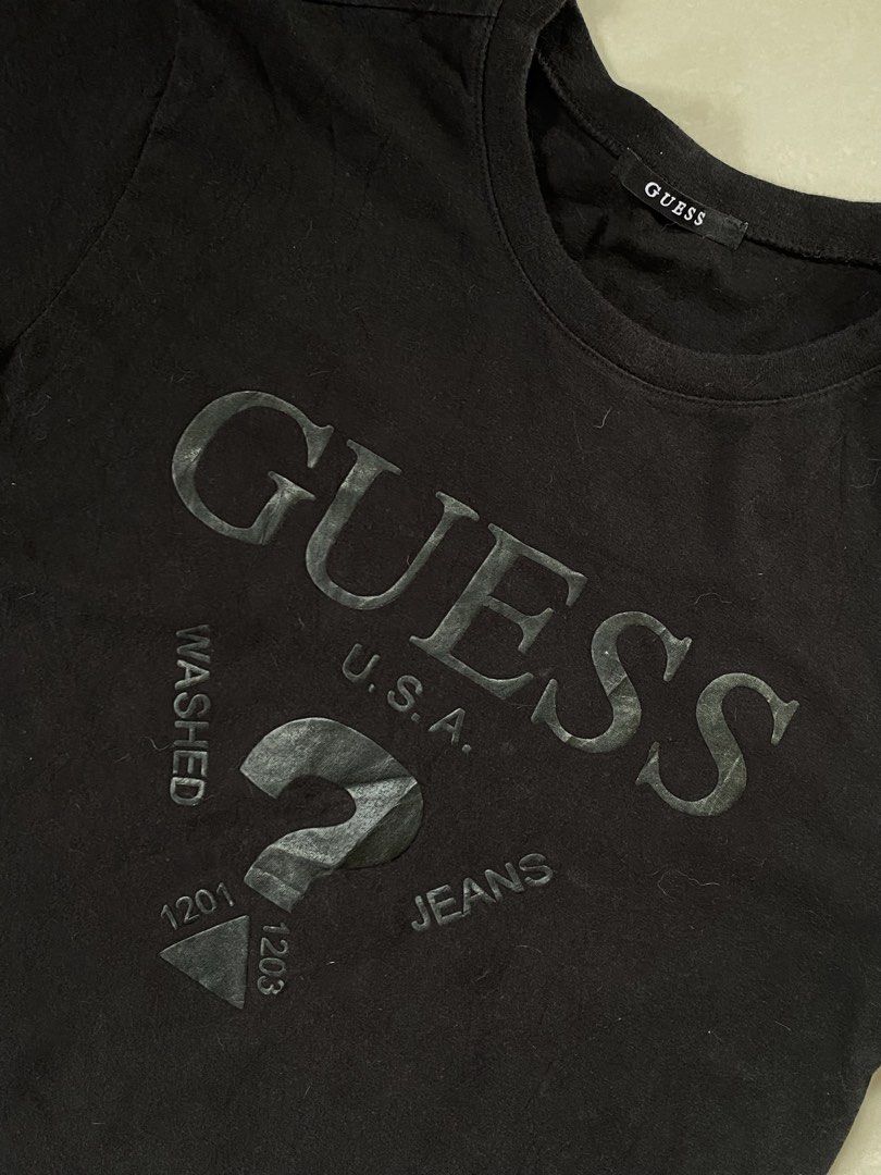 Black Guess USA T-shirt (Category: Tshirts & Polo Shirts ) located in Cabadbaran. Submitted by jersey.cobyming (Listing ID 1452916420, Image 3). Description: - Brand: Guess USA - Color: Black - Logo: Classic question mark logo - Material: Cotton - Origin: Made in Korea - Size: Medium (M) - Style: Casual wear Dimes: L: 26.5" W: 20".