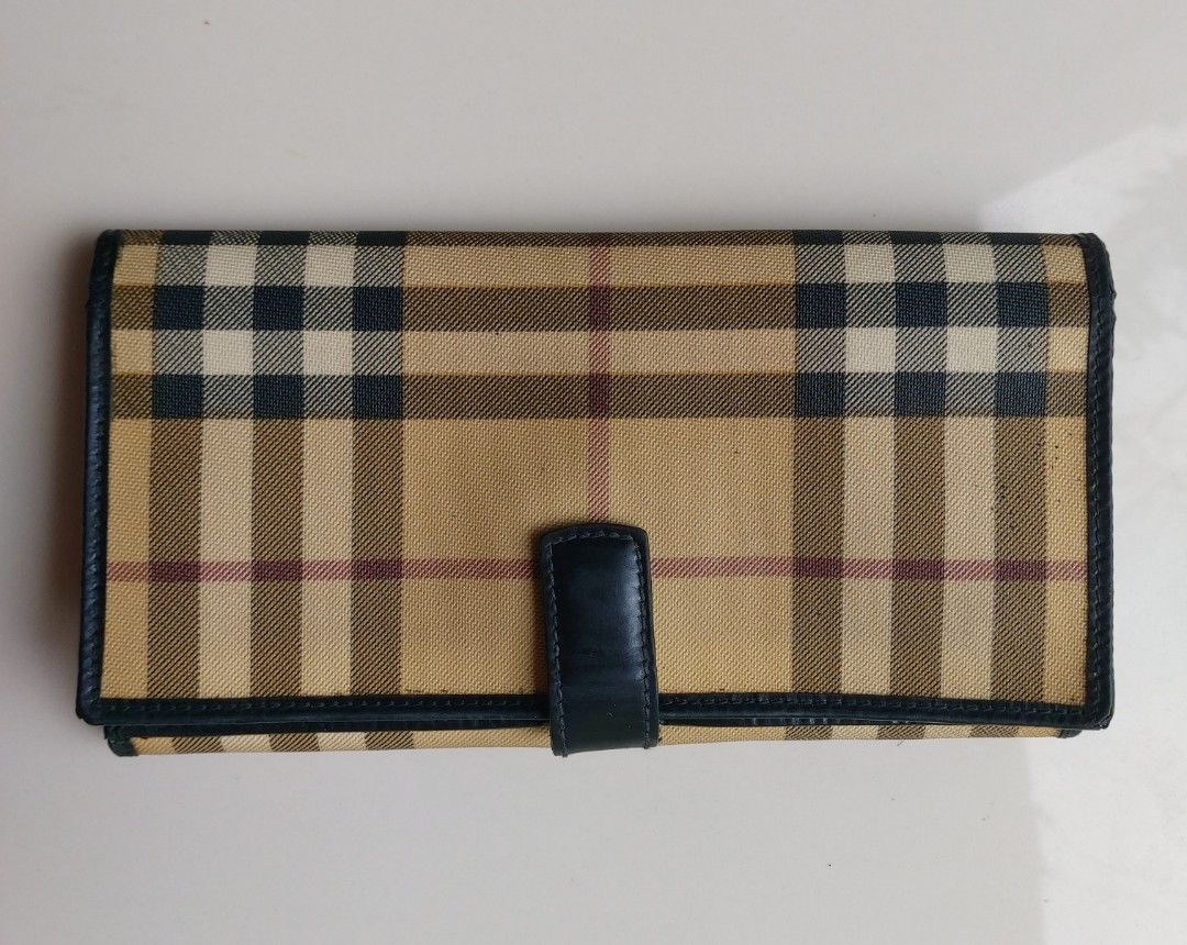 Burberry Long Wallet (Category: Luxury Bags & Wallets) located in Lapu Lapu. Submitted by agnesapm_29813 (Listing ID 1452996960, Image 3). Description: - Classic Burberry wallet - Iconic plaid pattern with leather trim - Stamped 'Burberry London Made in Italy' - Plenty of space for cards and cash - Timeless and authentic piece - Measurements: 7.5" x 4".