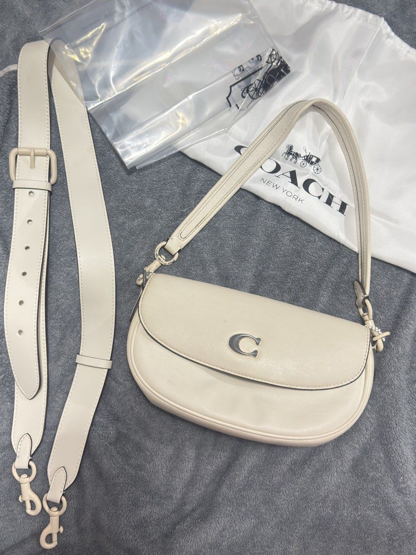 Coach Cream Leather Shoulder Bag with Detachable Strap (Category: Luxury Bags & Wallets) located in Manila. Submitted by kaletzclozet (Listing ID 1452882315, Image 1). Description: Cream leather shoulder bag from Coach. Comes with a detachable strap for versatility. The interior is lined with a tan suede-like material and has a zip pocket. Hardware is silver-toned. Includes the original dust bag. Great for everyday use or special occasions..