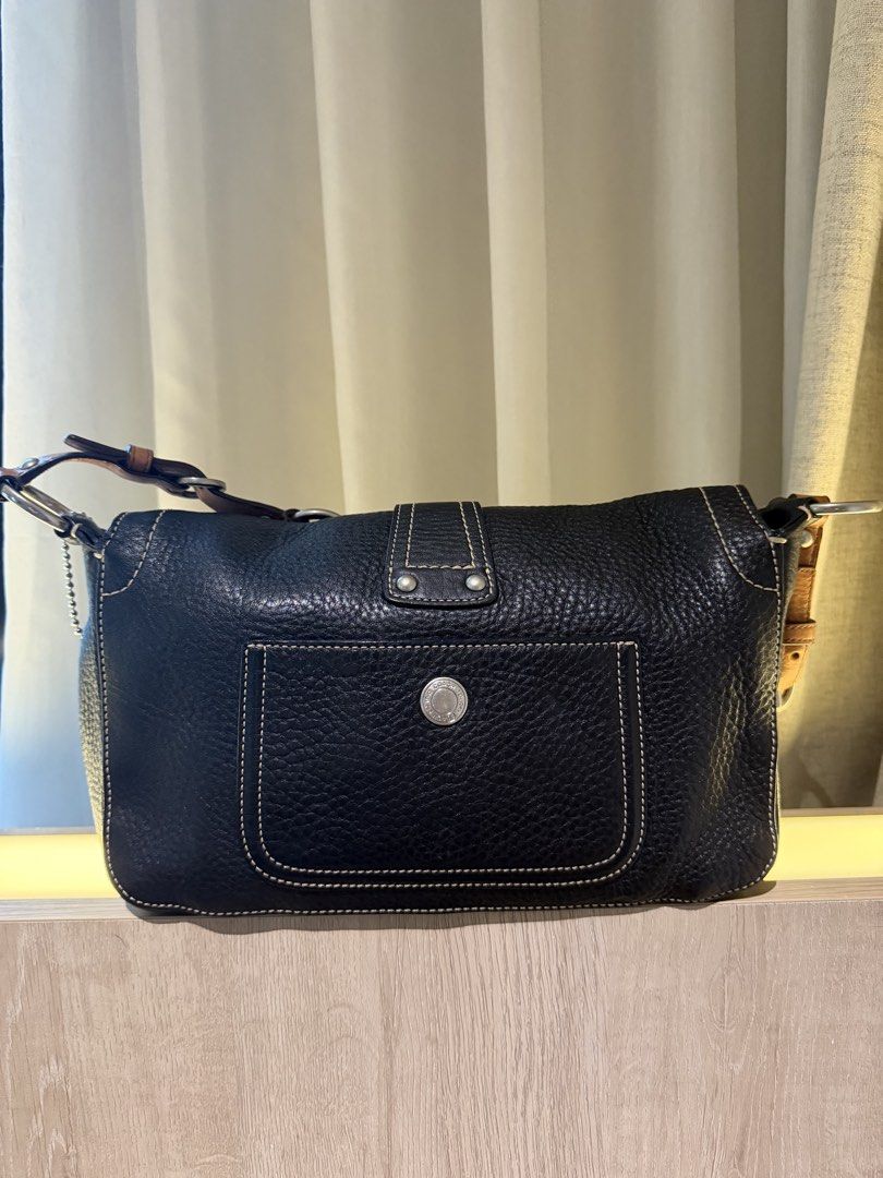 Coach Double Pocket Chelsea (Category: Luxury Bags & Wallets) located in Bulacan. Submitted by arianecleansupcloset (Listing ID 1451459288, Image 2). Description: - Classic black pebbled leather shoulder bag by Coach - Tan leather strap with adjustable buckle detail - Silver hardware accents, including a prominent O-ring on the front flap - Clean and spacious interior - Ideal for everyday wear.