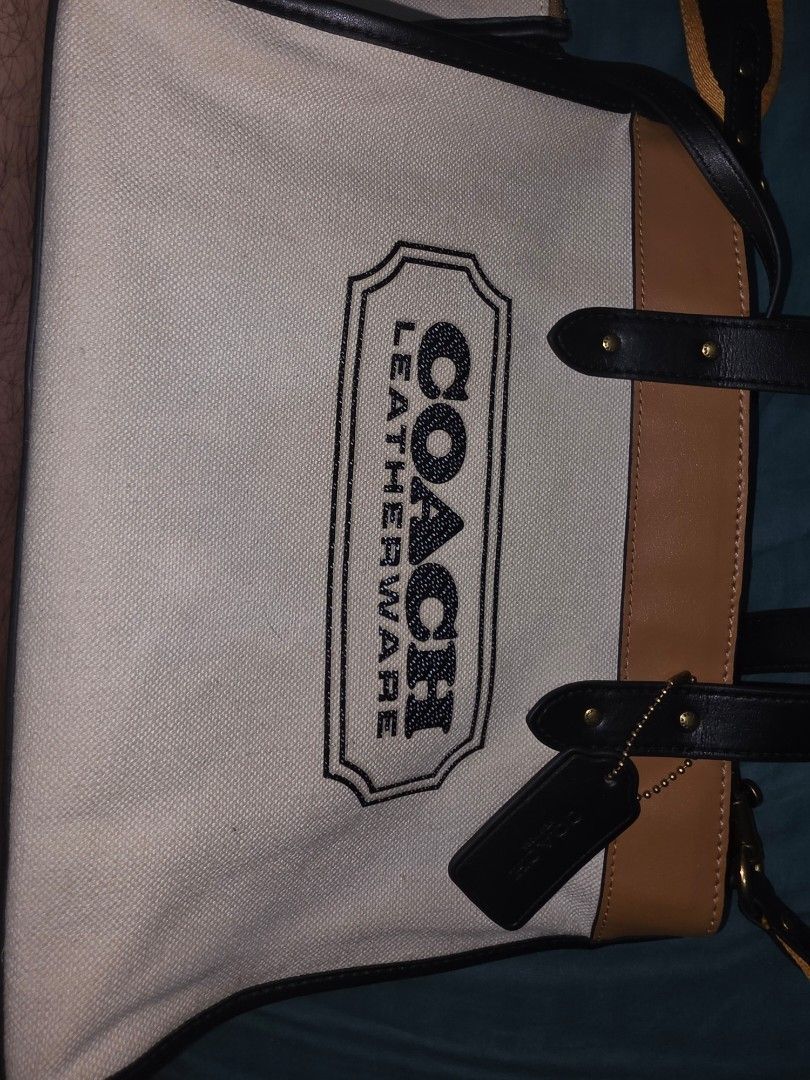 Coach Field tote 30cm canvas (Category: Luxury Bags & Wallets) located in Quezon City. Submitted by preloveditems.qc (Listing ID 1452926883, Image 3). Description: - Authentic Coach tote bag -9.5/10 Condition - Durable canvas and tan leather construction - Stylish black and yellow striped strap - Includes a matching canvas pouch - Interior zippered pocket for secure storage - Elegant gold hardware details - Ideal for everyday errands and activiti