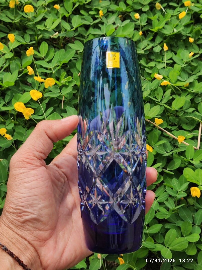 Edo Kiriko Kagami Crystal Cut Vase (Category: Vases & Decorative Bowls) located in Tagum. Submitted by cs1907 (Listing ID 1452920409, Image 3). Description: - 18cm tall -No chip -Stunning blue glass vase with intricate crystal cuts. - Unique color gradient: deep blue at the base, transitioning to blue/green at the top. - Substantial weight for a premium feel. - Ideal for floral arrangements or as a standalone decor piece. - Dimensions: Approximat