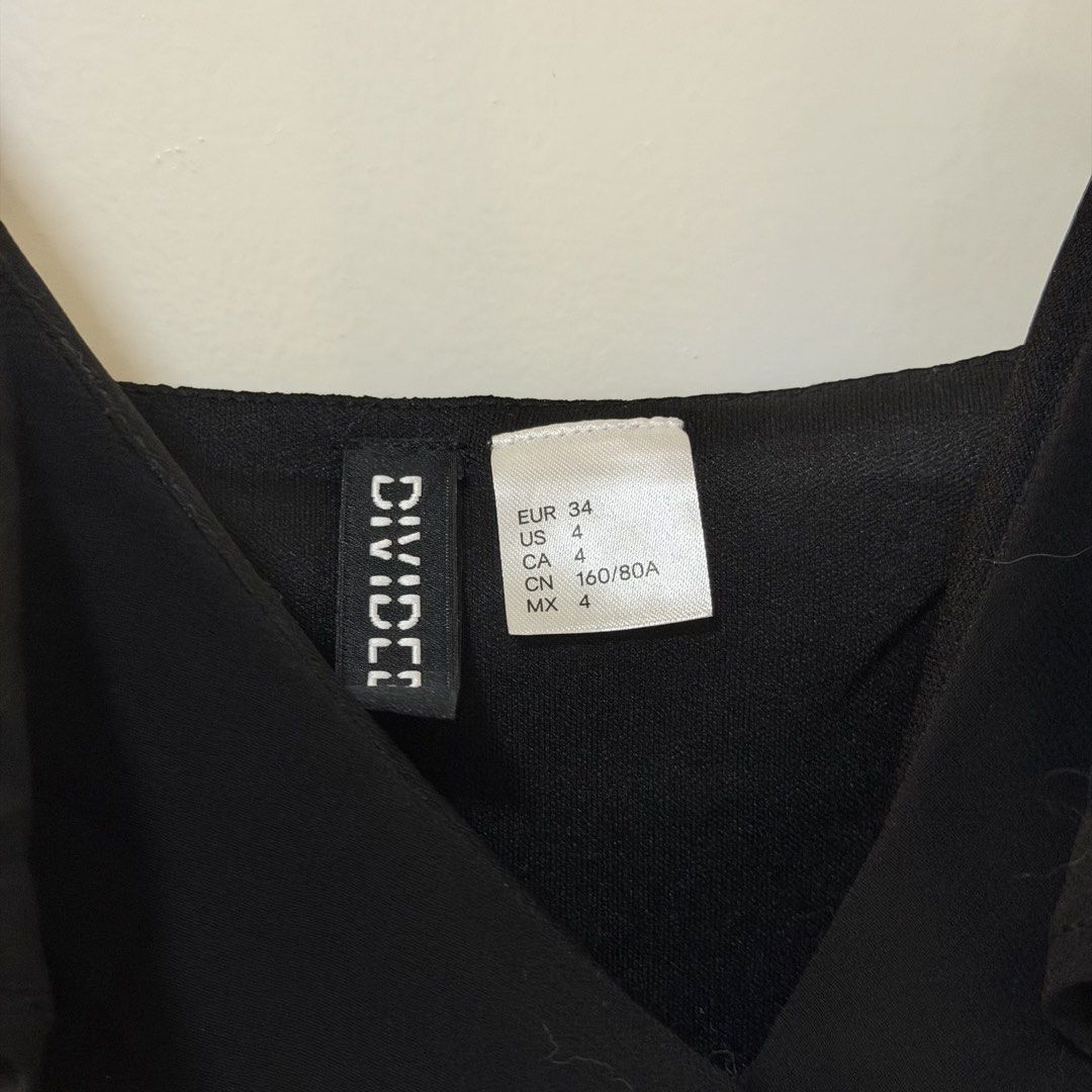 H&M Divided Black Ruffle Strap Dress (Category: Dresses) located in Bulacan. Submitted by declutter_diary02 (Listing ID 1452885922, Image 3). Description: - Brand: H&M Divided - Color: Black - Size: 4 / Small - Style: Spaghetti strap dress - Details: Ruffle detail, adjustable straps, elasticated waist - Skirt: Flowy chiffon PLEASE READ ‼️ MOP: Gcash or Bank transfer MOD: Lalamove/Grab or J&T (pickup only) Pickup time 12 PM ONWARDS Buyer will book