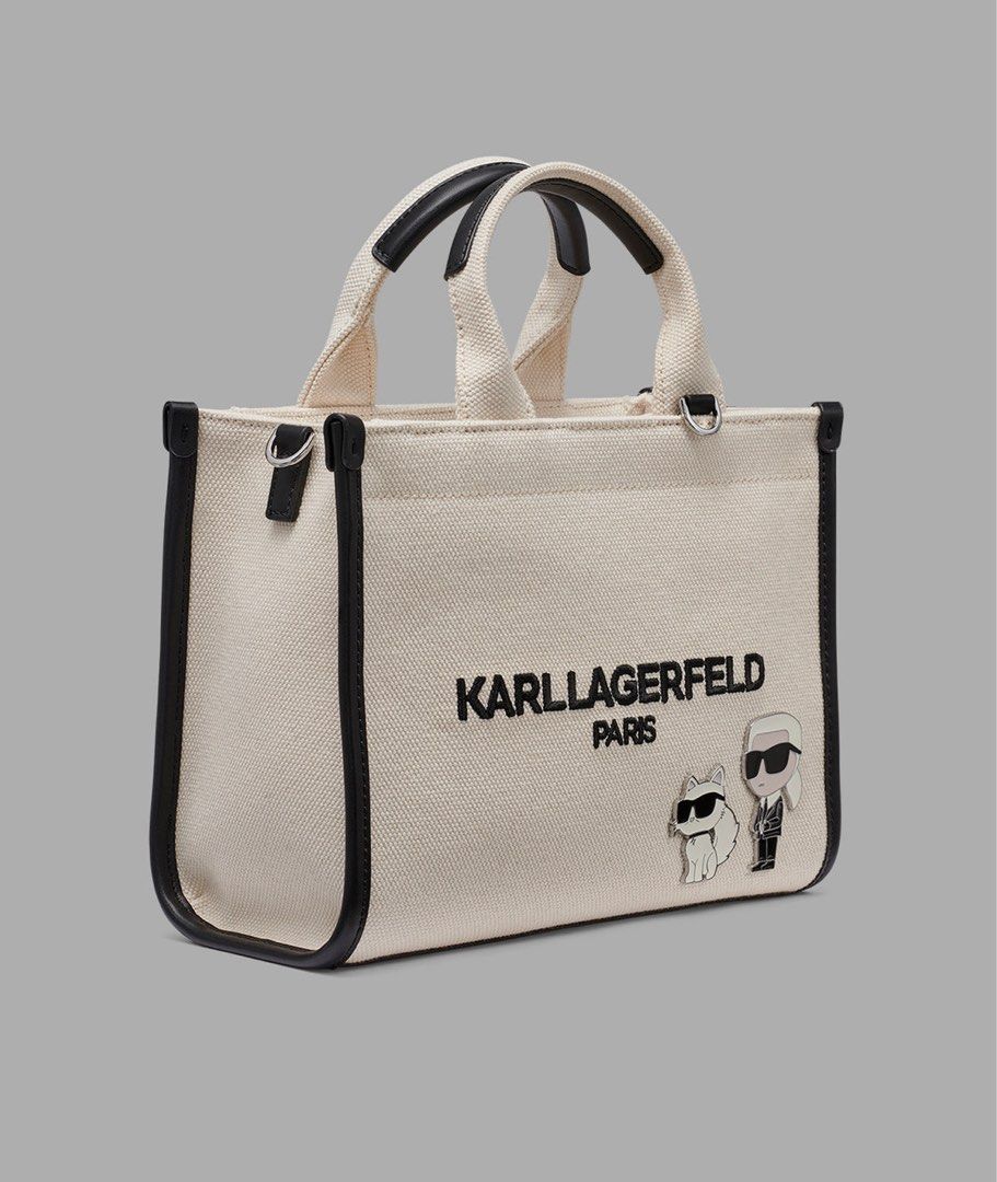 Karl Lagerfeld Kristina (Category: Tote Bags) located in Las Pinas. Submitted by mailoooooveszx (Listing ID 1452994180, Image 2). Description: - Cute Karl Lagerfeld tote bag - Cream canvas with black trim - Features Karl Lagerfeld Paris logo - Includes two adorable Karl charms - Top handles - Detachable shoulder strap - Interior patterned lining - Interior zip pocket - Great for everyday use.