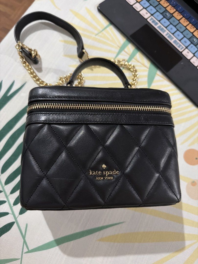 Kate Spade Black Quilted Vanity Case Bag (Category: Luxury Bags & Wallets) located in Muntinlupa City. Submitted by pinkfire1527 (Listing ID 1452900459, Image 1). Description: - Brand: Kate Spade - Style: Quilted Vanity Case - Color: Black - Hardware: Gold - Closure: Zipper - Strap: Chain strap included - Interior: Black - Use: Ideal for makeup or small essentials - Dimensions: Approximately 7" (L) x 5" (W) x 4" (H).