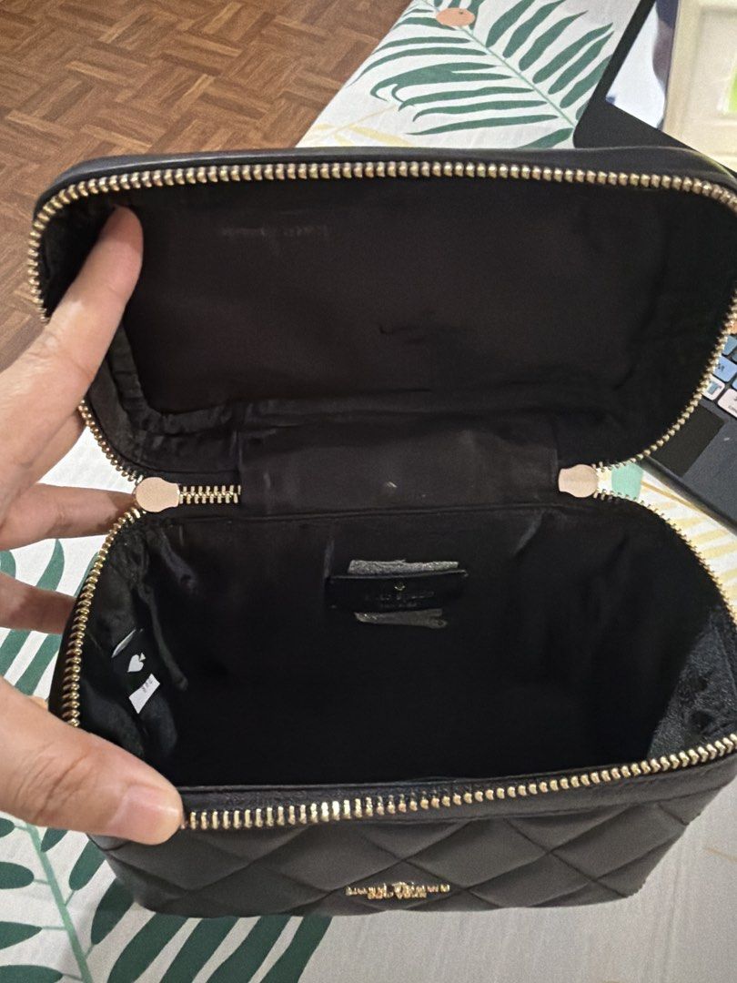Kate Spade Black Quilted Vanity Case Bag (Category: Luxury Bags & Wallets) located in Muntinlupa City. Submitted by pinkfire1527 (Listing ID 1452900459, Image 3). Description: - Brand: Kate Spade - Style: Quilted Vanity Case - Color: Black - Hardware: Gold - Closure: Zipper - Strap: Chain strap included - Interior: Black - Use: Ideal for makeup or small essentials - Dimensions: Approximately 7" (L) x 5" (W) x 4" (H).