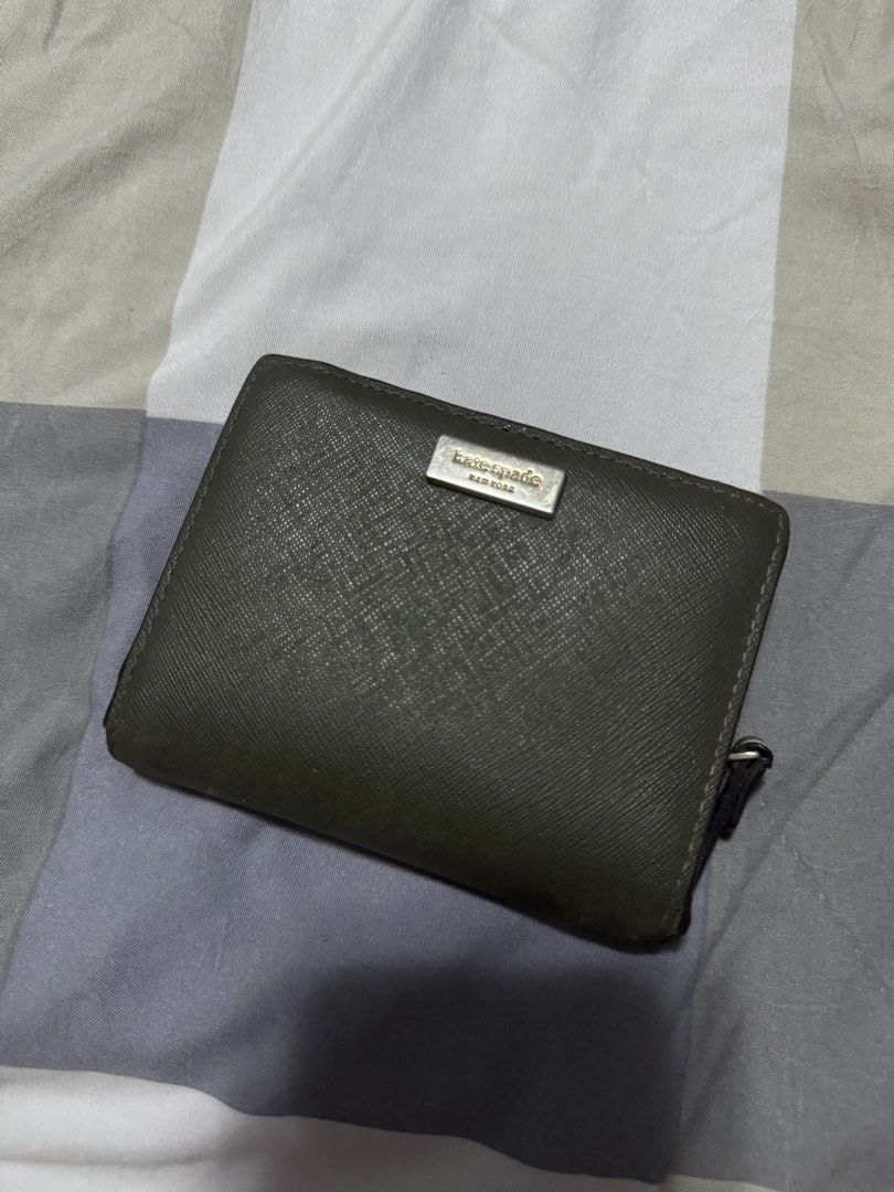Kate Spade Trifold Olive Green Wallet (Category: Wallets & Card holders) located in Tarlac. Submitted by mystelriousclutt3rs (Listing ID 1452931337, Image 1). Description: issues (pls see photos for issues): - heavy corner wear - peeling along the fold/hinge - scratches this is an authentic kate spade wallet. bought in hk, no receipt since it’s an old wallet mod: j&t mop: gcash no return and refund.