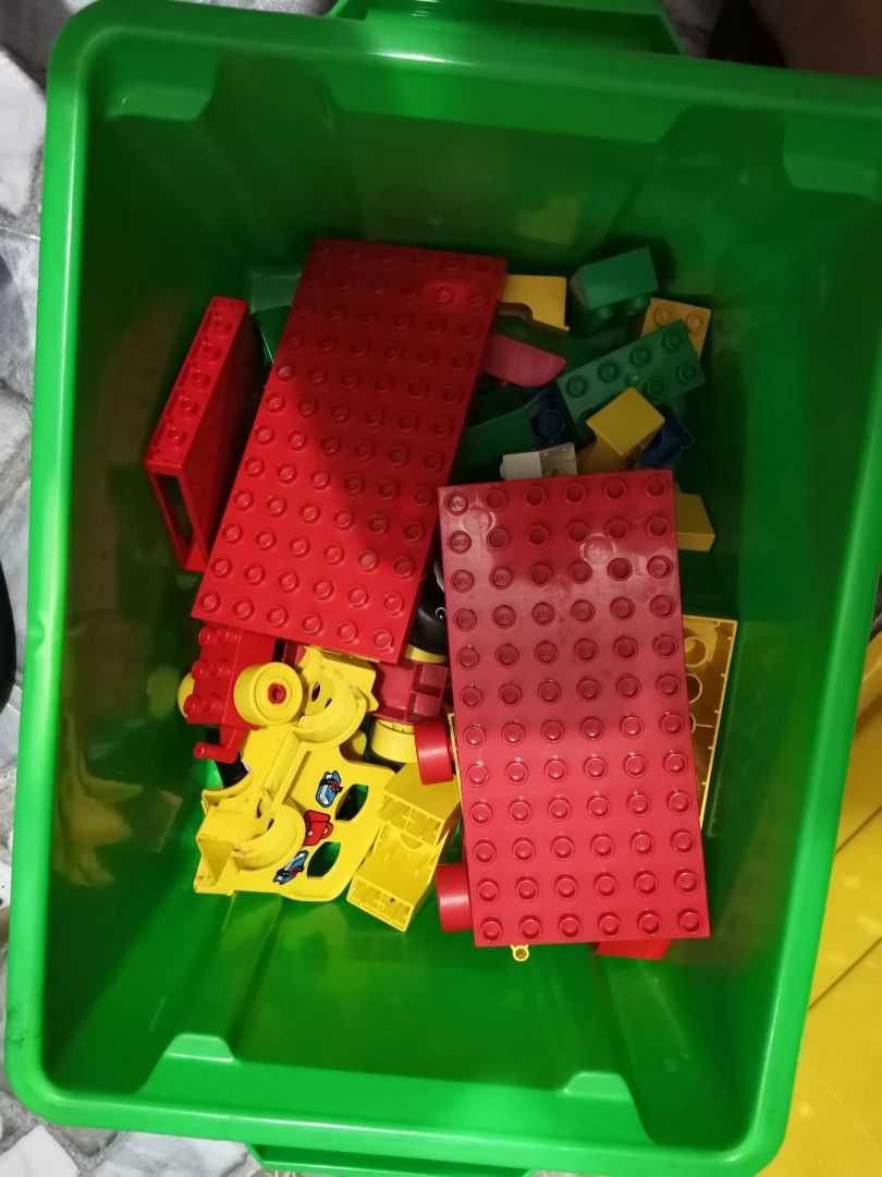 LEGO Duplo Green Storage Box with Assorted Bricks (Category: Lego & Building Sets) located in Quezon City. Submitted by heybailey (Listing ID 1452937550, Image 2). Description: - Green LEGO storage bin with yellow lid - Includes a collection of Duplo bricks - Features large red base plates - Comes with a yellow car piece - Includes red and blue connector bricks - Assorted other Duplo blocks included - Ideal for organizing toys - Great for imagina
