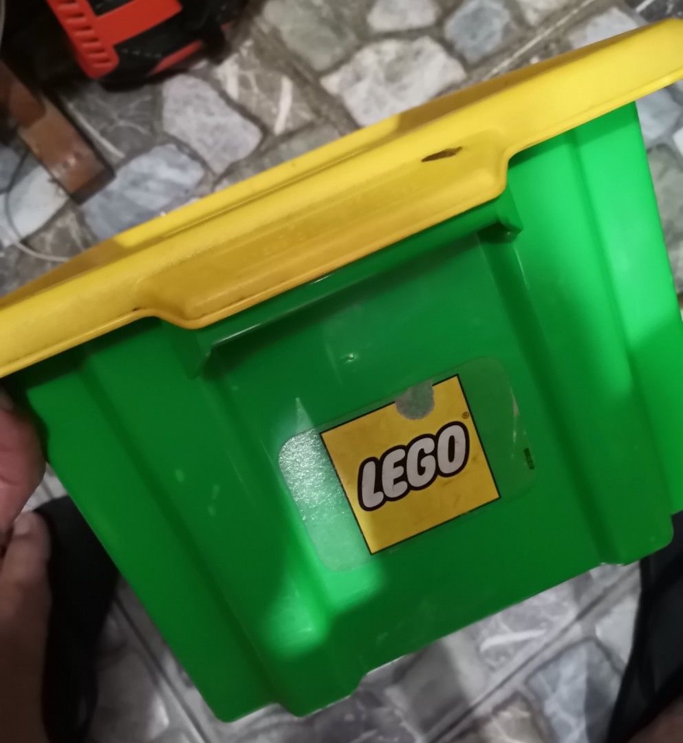 LEGO Duplo Green Storage Box with Assorted Bricks (Category: Lego & Building Sets) located in Quezon City. Submitted by heybailey (Listing ID 1452937550, Image 3). Description: - Green LEGO storage bin with yellow lid - Includes a collection of Duplo bricks - Features large red base plates - Comes with a yellow car piece - Includes red and blue connector bricks - Assorted other Duplo blocks included - Ideal for organizing toys - Great for imagina