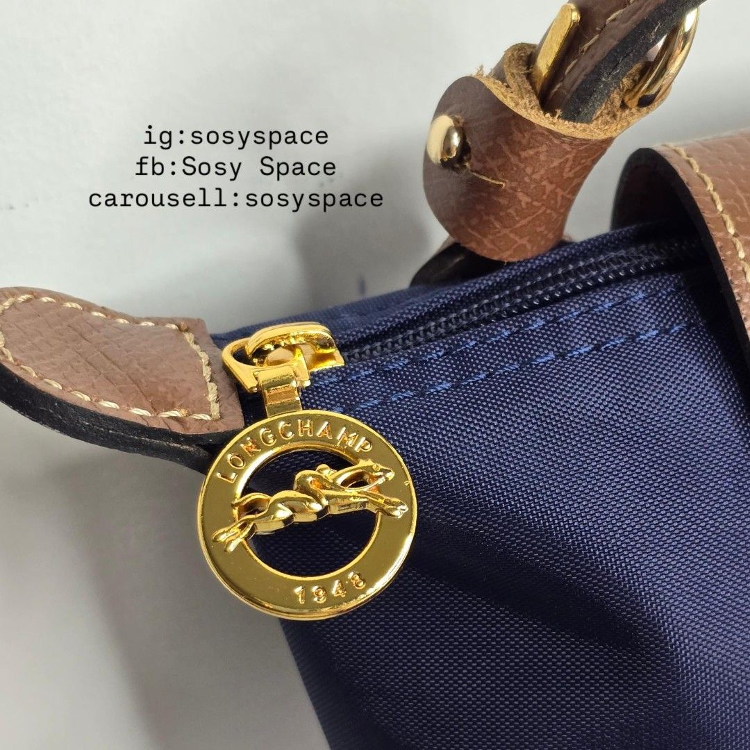 Longchamp Le Pliage Original Pouch With Handle And Sling Strap (Category: Luxury Bags & Wallets) located in Lucena. Submitted by sosyspace (Listing ID 1452905239, Image 3). Description: L. O. N. G. C. H. A. M. P. 04B2P77 Le Pliage Pouch w/ Handle and Sling Strap 34175089556 Navy 6.7 x 2.2 x 4.3 inches Recycled Polyamide Canvas W/ Inside Coating Russian Cowhide Leather Gold Hardware Snap Button and Zip Closure France Condition: Brand New Final Pri
