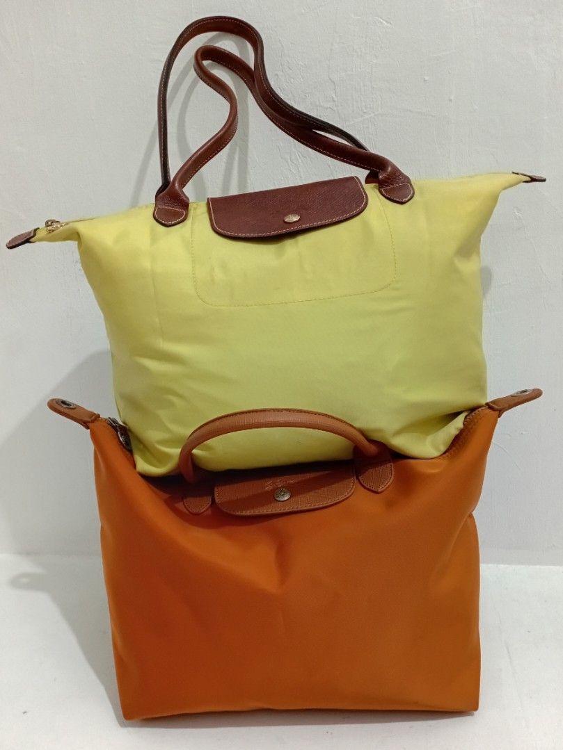 Longchamp Pliage. Original large Shoulder Tote Bag - Yellow (Category: Luxury Bags & Wallets) located in Navotas City. Submitted by riyuwi (Listing ID 1450509231, Image 1). Description: PreOwned Lightly Used Authentic Classic yellow Longchamp Pliage Original. Large Shoulder tote bag -long handle. Strap - Genuine leather handles and trim - Secure Ykk zipper closure with snap button flap (ORIGINAL .PRYM wth Hard jelly tag intact inside - Large, spa