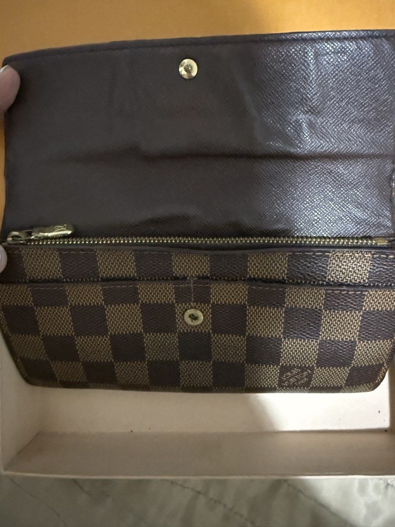 Louis Vuitton Damier Ebene Canvas Wallet (Category: Luxury Bags & Wallets) located in Quezon City. Submitted by aaathrifts (Listing ID 1452981680, Image 2). Description: - Authentic Louis Vuitton wallet - Damier Ebene canvas with classic checkered pattern - Multiple card slots - Zippered coin pocket - Made in Spain - Includes original Louis Vuitton box.
