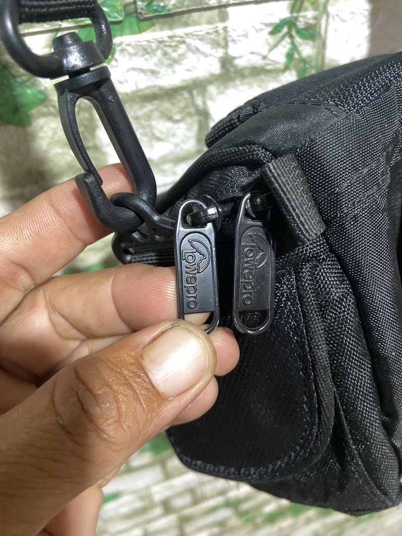 Lowepro Black Camera Bag (Category: Camera Bags & Carriers) located in Davao. Submitted by mengsmixitems (Listing ID 1452912088, Image 3). Description: - Black Lowepro camera bag - Padded interior with mesh pocket - Lowepro branded zippers - Adjustable shoulder strap included - Features www.lowepro.com on tag - Made from Polyethylene Foam and Rubber.