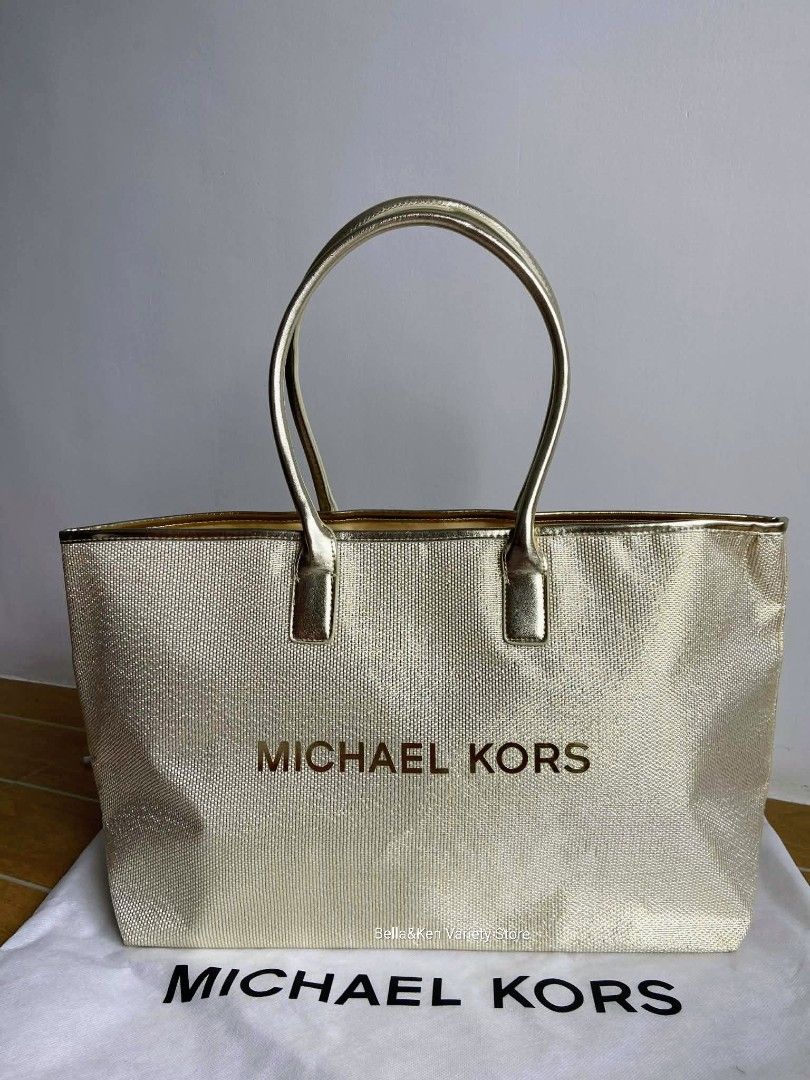 Michael Kors Gold Metallic Tote Bag GWP (Category: Luxury Bags & Wallets) located in Bulacan. Submitted by bella.ken.varietystore (Listing ID 1453041340, Image 1). Description: - Genuine Michael Kors tote bag in a stunning gold color. - Eye-catching woven metallic exterior texture. - Smooth gold fabric interior lining. - Shiny gold handles for a polished look. - Ample interior space for your daily essentials. - Comes with its original dust bag fo