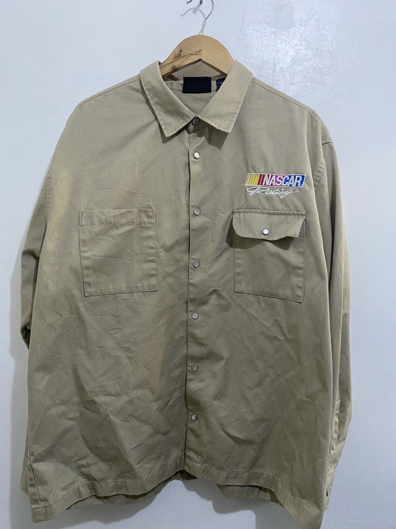 NASCAR Racing Jacket - Official Licensed Merchandise (Category: Coats, Jackets and Outerwear) located in Calamba. Submitted by curlybang (Listing ID 1452900091, Image 1). Description: - Cool tan NASCAR Racing jacket - Official NASCAR logo on the front - Large graphic design on the back - Made from a comfortable polyester and cotton blend - Features a secure snap button closure - Two convenient chest pockets - Ideal for any racing enthusiast.