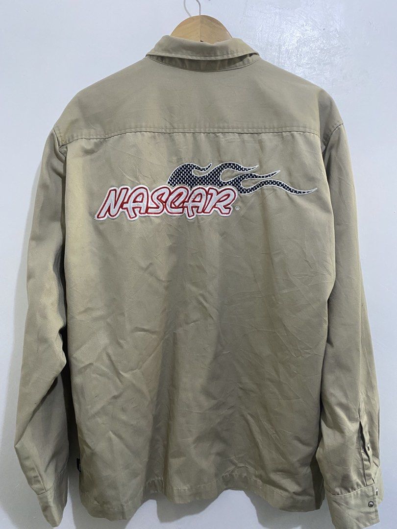 NASCAR Racing Jacket - Official Licensed Merchandise (Category: Coats, Jackets and Outerwear) located in Calamba. Submitted by curlybang (Listing ID 1452900091, Image 2). Description: - Cool tan NASCAR Racing jacket - Official NASCAR logo on the front - Large graphic design on the back - Made from a comfortable polyester and cotton blend - Features a secure snap button closure - Two convenient chest pockets - Ideal for any racing enthusiast.