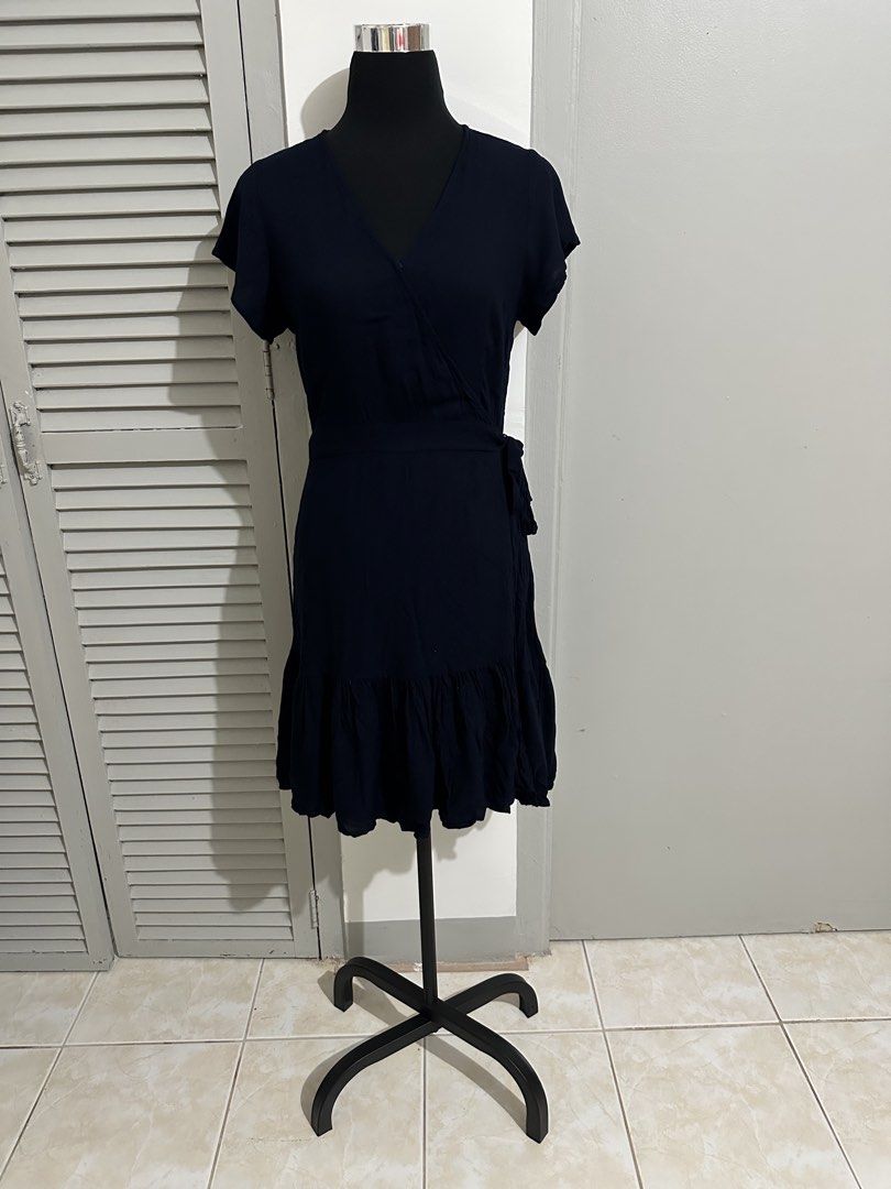 Navy Blue Wrap Dress with Ruffle Hem (Category: Dresses) located in Balanga. Submitted by ruffa_assorted_item (Listing ID 1452889710, Image 1). Description: - Navy blue wrap dress - Short sleeves - V-neckline - Side ties - Ruffle detail along the hem - Comfortable and versatile - Easy to style up or down.