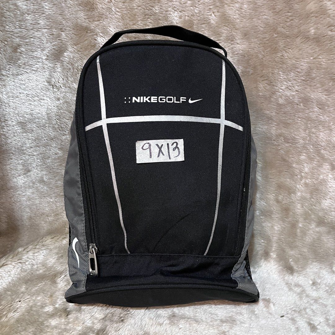 Nike Golf Shoe Bag Black (Category: Golf) located in Butuan. Submitted by dfgthriftology2.0 (Listing ID 1452938064, Image 1). Description: - Nike Golf Shoe Bag - Color: Black with Grey accents - Top handle for easy carrying - Zippered main compartment - Mesh side panels for ventilation - Interior mesh pockets - Ideal for keeping golf shoes clean and organized.
