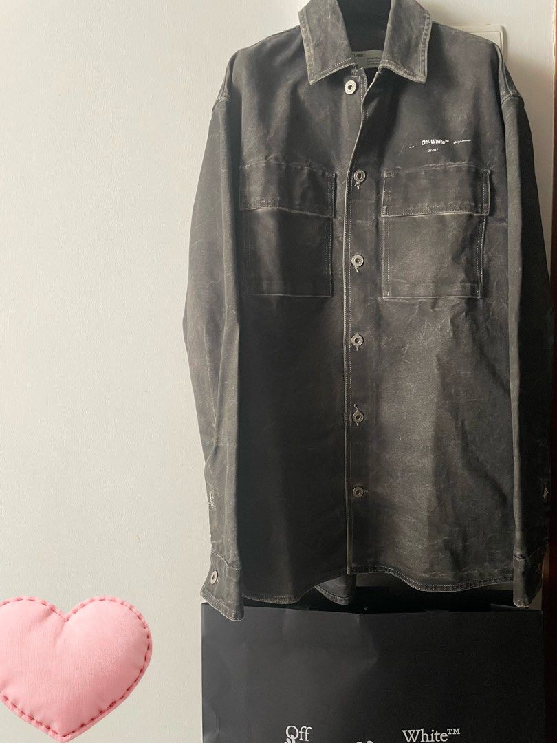 OFF-WHITE™ Jacket (Category: Apparel) located in Singapore. Submitted by zhuhing563707 (Listing ID 1452993491, Image 1). Description: - Authentic OFF-WHITE™ shirt jacket - Color: Dark grey/charcoal with a washed-out effect - Features signature OFF-WHITE™ logo and '2010' print on chest - Two chest pockets with button closures - Button-up front - Comes with original OFF-WHITE™ shopping bag No return .