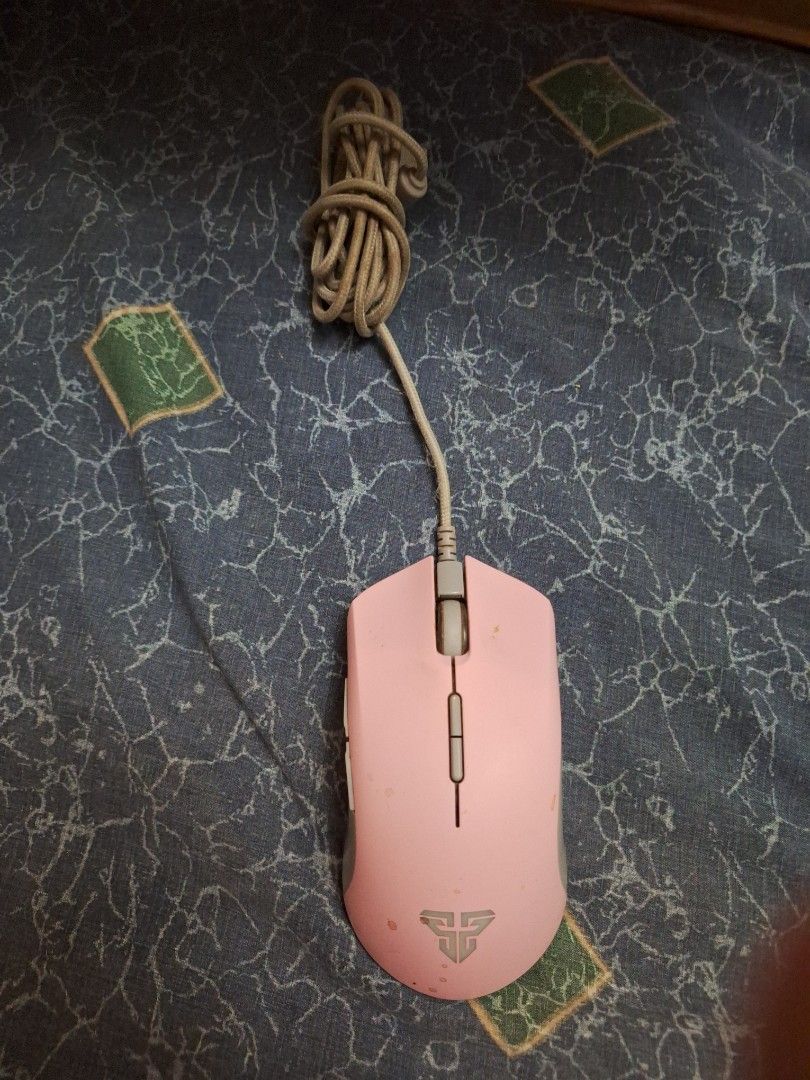 Pink Fantech Gaming Mouse (Category: Mouse & Mousepads) located in Manila. Submitted by ags028705 (Listing ID 1453017435, Image 1). Description: - Pink Fantech gaming mouse - Braided cable for durability - Minor cosmetic scuffs and dirt marks visible - Fully functional and works great - Ideal for gaming and everyday computer use.