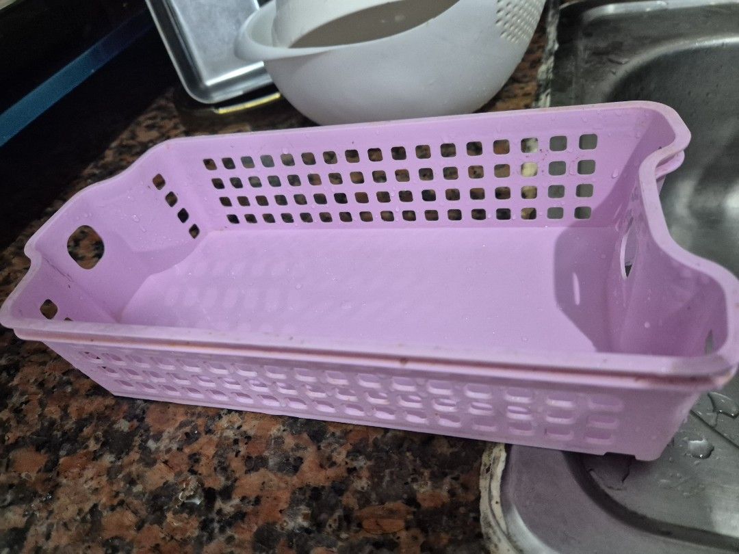 Pink Plastic Storage Basket Organizer (Category: Storage Boxes & Baskets) located in Manila. Submitted by zotag (Listing ID 1452988100, Image 2). Description: - Pink plastic storage basket - Rectangular shape with convenient cut-out handles - Grid pattern on sides and bottom for drainage/ventilation - Ideal for organizing small items in the kitchen, bathroom, or desk.