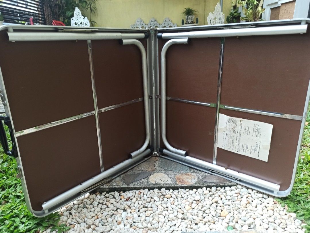 Portable Folding Table for Camping and Picnics (Category: Tables & Sets) located in Caloocan City. Submitted by rtarellano (Listing ID 1452958819, Image 2). Description: - Adjustable height up to 70 cm, Portable folding table. Excellent condition - Granite-look tabletop - Aluminum Silver legs - Folds in half for easy storage and transport - Built-in handle for carrying - Ideal for camping, picnics, and extra home use - Sturdy and practical design