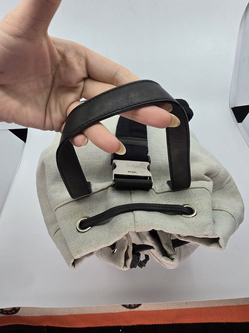 Prada Canapa Knapsack (Category: Luxury Bags & Wallets) located in Quezon City. Submitted by nadine_miel (Listing ID 1453031318, Image 3). Description: Project bag⚠️ Prada Canapa Knapsack body bag have visible discoloration on the canvas leather trimming sa drawstring mejo buka na but still perfect pa naman conditiob perfect pa to pang harabas or png pickle ball ksi madmi malalagay.