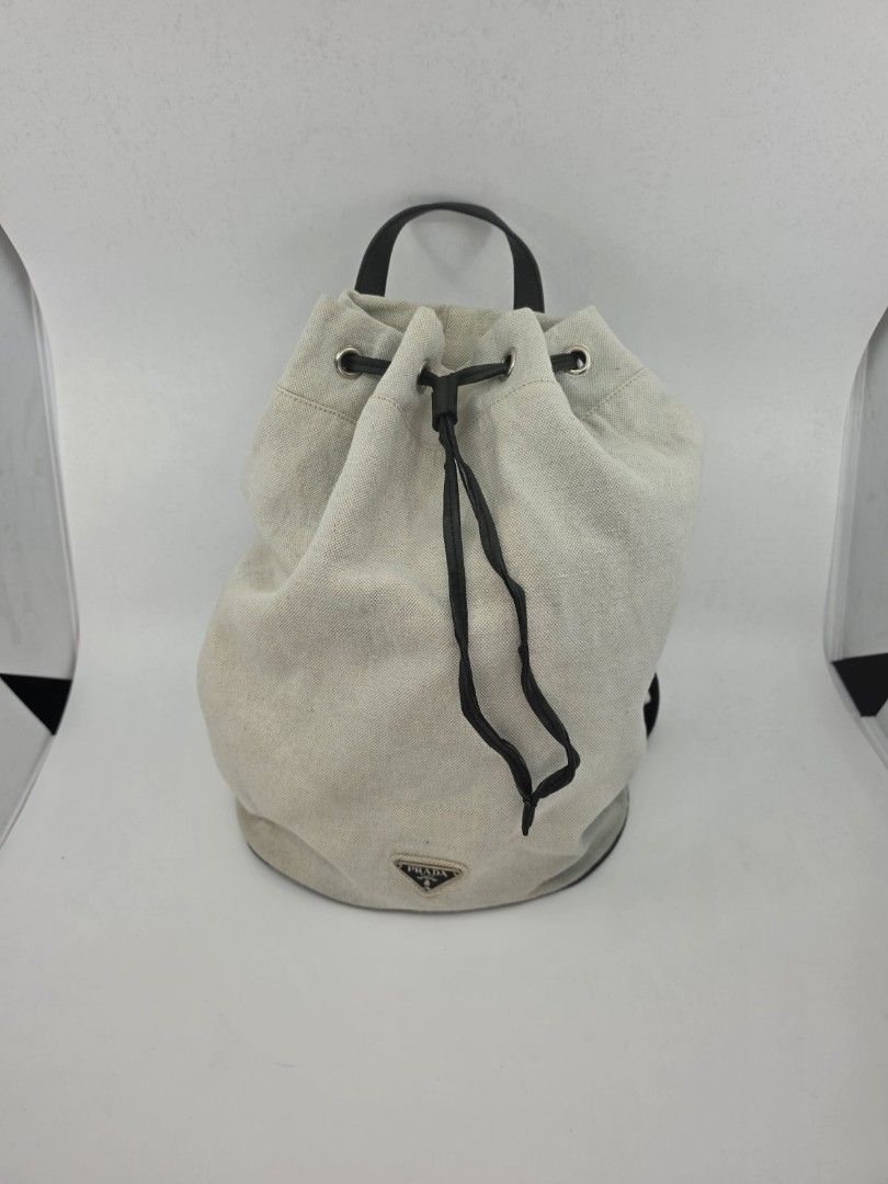 Prada Canapa Knapsack (Category: Luxury Bags & Wallets) located in Quezon City. Submitted by nadine_miel (Listing ID 1453031318, Image 1). Description: Project bag⚠️ Prada Canapa Knapsack body bag have visible discoloration on the canvas leather trimming sa drawstring mejo buka na but still perfect pa naman conditiob perfect pa to pang harabas or png pickle ball ksi madmi malalagay.